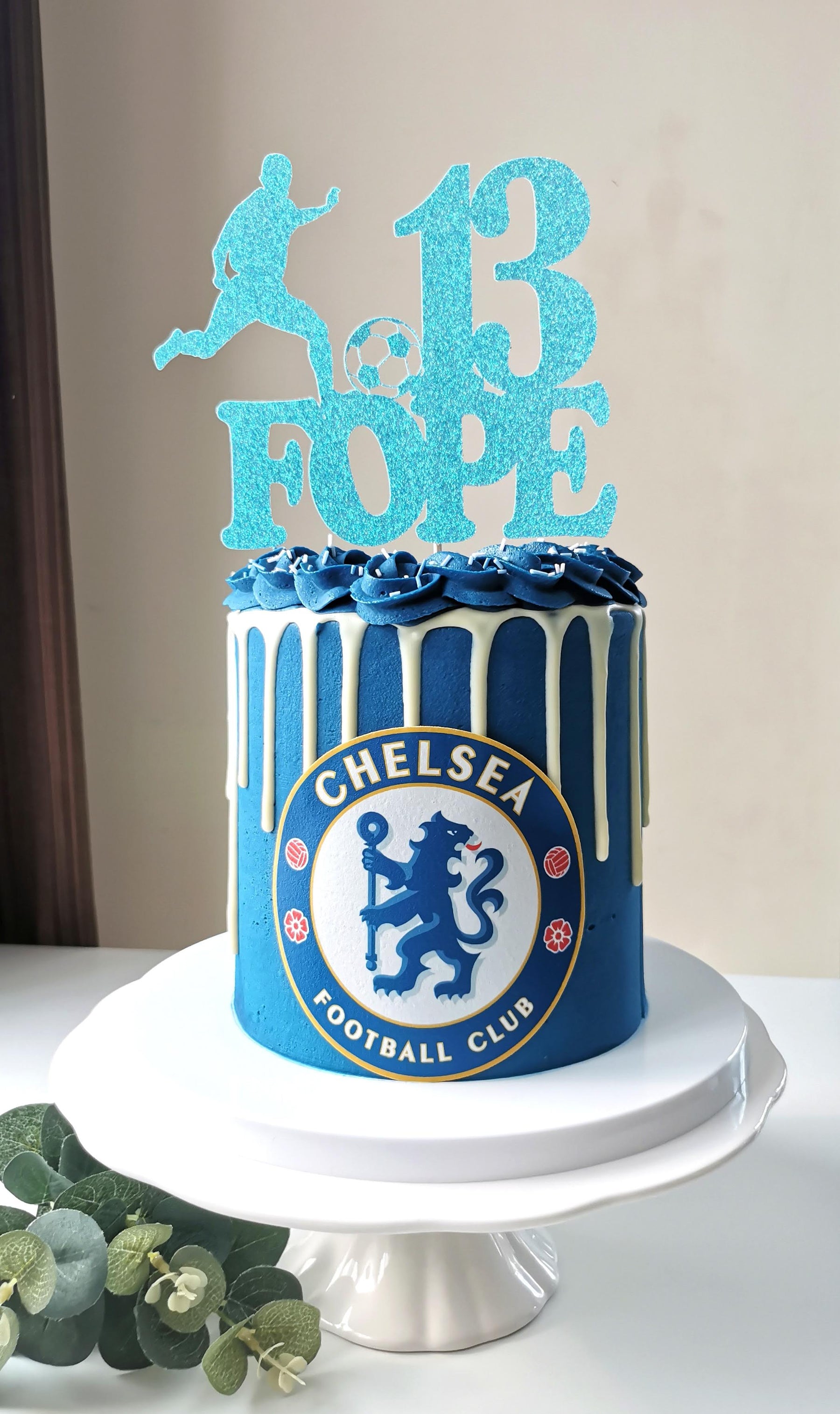 Cake in Chelsea football brand colours with a cake topper